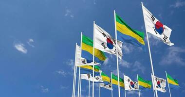 gabon och söder korea flaggor vinka tillsammans i de himmel, sömlös slinga i vind, Plats på vänster sida för design eller information, 3d tolkning video