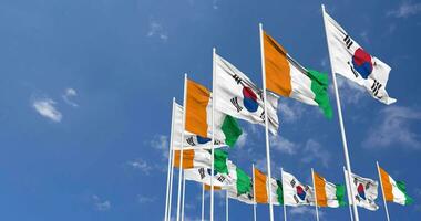 Marfil costa y sur Corea banderas ondulación juntos en el cielo, sin costura lazo en viento, espacio en izquierda lado para diseño o información, 3d representación video