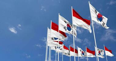 Indonesia and South Korea Flags Waving Together in the Sky, Seamless Loop in Wind, Space on Left Side for Design or Information, 3D Rendering video