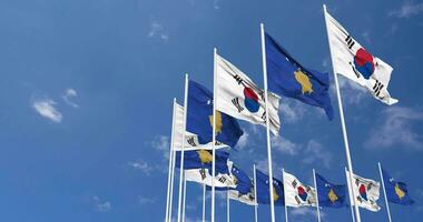 kosovo e Sud Corea bandiere agitando insieme nel il cielo, senza soluzione di continuità ciclo continuo nel vento, spazio su sinistra lato per design o informazione, 3d interpretazione video