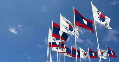 Laos and South Korea Flags Waving Together in the Sky, Seamless Loop in Wind, Space on Left Side for Design or Information, 3D Rendering video