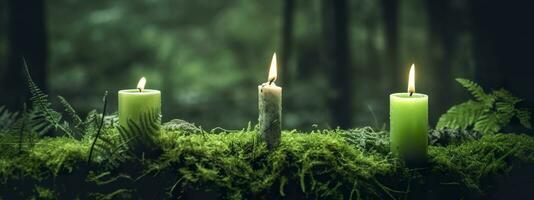 AI generated Burning candles on moss, dark green blurred the natural background. Magic candle. Generative AI photo