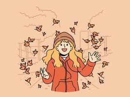 Little girl throws up leaves of autumn trees walking in park and rejoices at end of summer vector