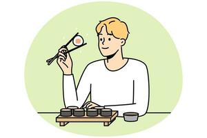 el hombre sonriente se sienta a la mesa en el restaurante comiendo sushi con palillos. un tipo feliz disfruta de la comida asiática tradicional en un café o bar. ilustración vectorial vector