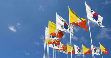 Bhutan and South Korea Flags Waving Together in the Sky, Seamless Loop in Wind, Space on Left Side for Design or Information, 3D Rendering video