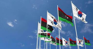 Libya and South Korea Flags Waving Together in the Sky, Seamless Loop in Wind, Space on Left Side for Design or Information, 3D Rendering video