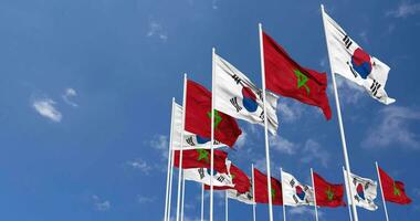 Morocco and South Korea Flags Waving Together in the Sky, Seamless Loop in Wind, Space on Left Side for Design or Information, 3D Rendering video