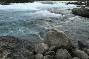 Rapids at the confluence of blue Baker river and grey Neff river, Pan-American Highway between Cochrane and Puerto Guadal, Aysen Region, Patagonia, Chile photo