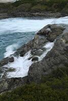 Rapids at the confluence of blue Baker river and grey Neff river, Pan-American Highway between Cochrane and Puerto Guadal, Aysen Region, Patagonia, Chile photo