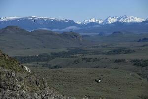 Andean Condors, Vultur gryphus, flying over high cliffs, Coyhaique Alto, Aysen Region, Patagonia, Chile photo