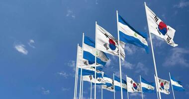 Nicaragua and South Korea Flags Waving Together in the Sky, Seamless Loop in Wind, Space on Left Side for Design or Information, 3D Rendering video