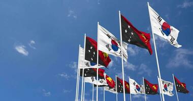 Papua New Guinea and South Korea Flags Waving Together in the Sky, Seamless Loop in Wind, Space on Left Side for Design or Information, 3D Rendering video