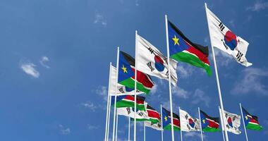 Sud Sudan e Sud Corea bandiere agitando insieme nel il cielo, senza soluzione di continuità ciclo continuo nel vento, spazio su sinistra lato per design o informazione, 3d interpretazione video