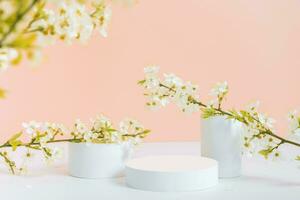 Empty podium or pedestal with spring bloom peach fuzz color background. Mock up for cosmetic products photo