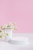 Empty podium or pedestal with spring bloom. Mock up for cosmetic products photo