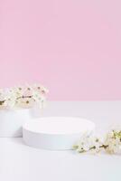 Empty podium or pedestal with spring bloom. Mock up for cosmetic products photo