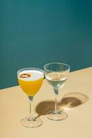 Alcoholic cocktail in two glasses on a colored background photo