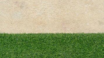 Above view of half artificial grass green color and cement floor. for background and textured. photo