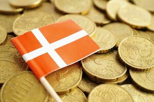 Denmark flag on coins background, finance and accounting, banking concept. photo