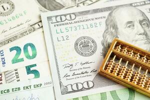 Gold abacus on banknote money, finance trading investment business currency concept. photo