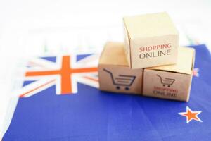 Online shopping, Shopping cart box on New Zealand flag, import export, finance commerce. photo