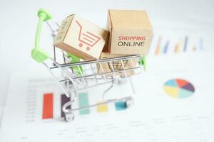 Online shopping, Shopping cart box on business graph, import export, finance commerce. photo