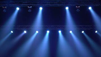 strobe blue light from stage lighting equipment in a concert hall video