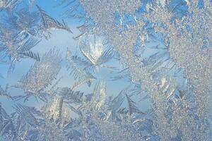 Abstract frosty pattern on glass, background ice texture photo