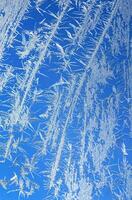 Ice on a window blue white vertical photo