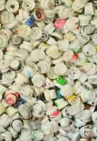 A pattern of many used and soiled nozzles from spray cans with aerosol paint. Background texture of the street art of drawing graffiti on the walls photo
