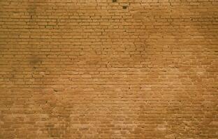 The texture of the brick wall of many rows of bricks painted in brown color photo