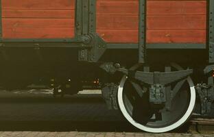 The side of the old brown wooden freight car with the wheel of the times of the Soviet Union photo