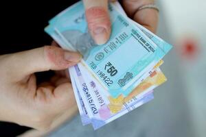 Woman hand with indian rupees bills. Concept of financial operations in cash in India photo