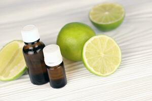 Oil essence bottle with citrus extracts. Selective focus. Spa day, concept of freshness oil bottle with lime photo