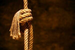 Noose in prison of old castle cellar and grunge stone wall photo