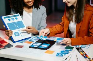 UX developer and ui designer brainstorming about mobile app interface wireframe design with customer breif and color code photo