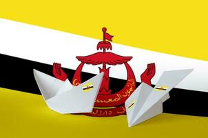 Brunei Darussalam flag depicted on paper origami airplane and boat. Handmade arts concept photo