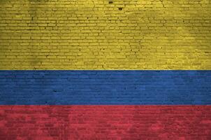 Colombia flag depicted in paint colors on old brick wall. Textured banner on big brick wall masonry background photo