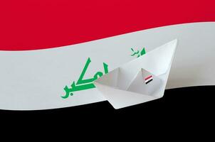 Iraq flag depicted on paper origami ship closeup. Handmade arts concept photo