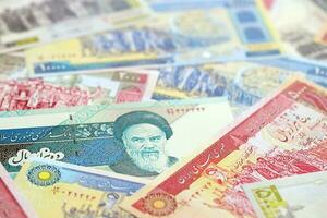 Big pile of Iranian Rial IRR banknotes from Iran as the background on flat surface photo