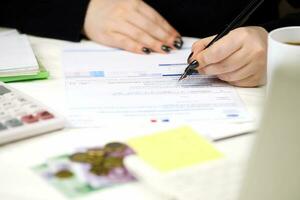 Accountant fill french tax form CA12 Value added tax and similar taxes in end of tax period. Taxation and paperwork routine photo