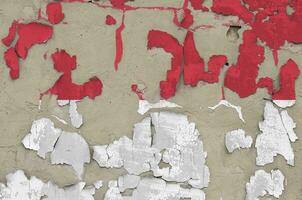 Indonesia flag depicted in paint colors on old obsolete messy concrete wall closeup. Textured banner on rough background photo