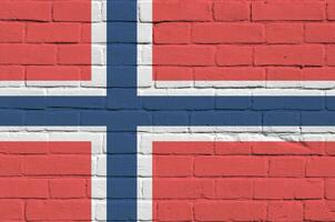 Norway flag depicted in paint colors on old brick wall. Textured banner on big brick wall masonry background photo