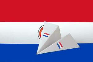 Paraguay flag depicted on paper origami airplane. Handmade arts concept photo