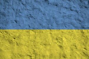 Ukraine flag depicted in bright paint colors on old relief plastering wall. Textured banner on rough background photo