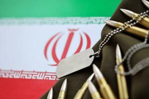 Many rifle bullets and dog tags with flag of Islamic Republic of Iran. The concept assault and terrorism photo