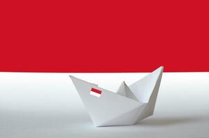 Monaco flag depicted on paper origami ship closeup. Handmade arts concept photo