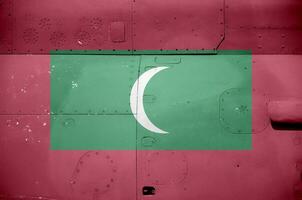 Maldives flag depicted on side part of military armored helicopter closeup. Army forces aircraft conceptual background photo