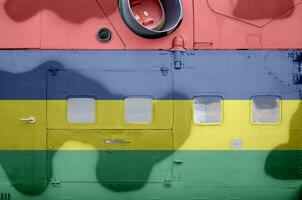 Mauritius flag depicted on side part of military armored helicopter closeup. Army forces aircraft conceptual background photo