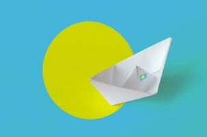 Palau flag depicted on paper origami ship closeup. Handmade arts concept photo